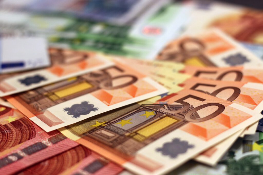 Zu sehen sind 50 Euroscheine, die auf einem Tisch liegen.